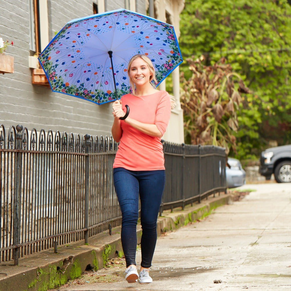 InBrella Reverse Close Umbrella in Flower Garden Lifestyle Shot in the Rain