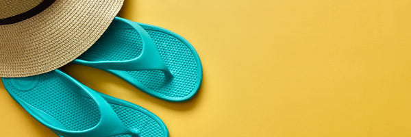 Women's Ara Flip Flop in Splash Blue with a sun hat on a sunny yellow background
