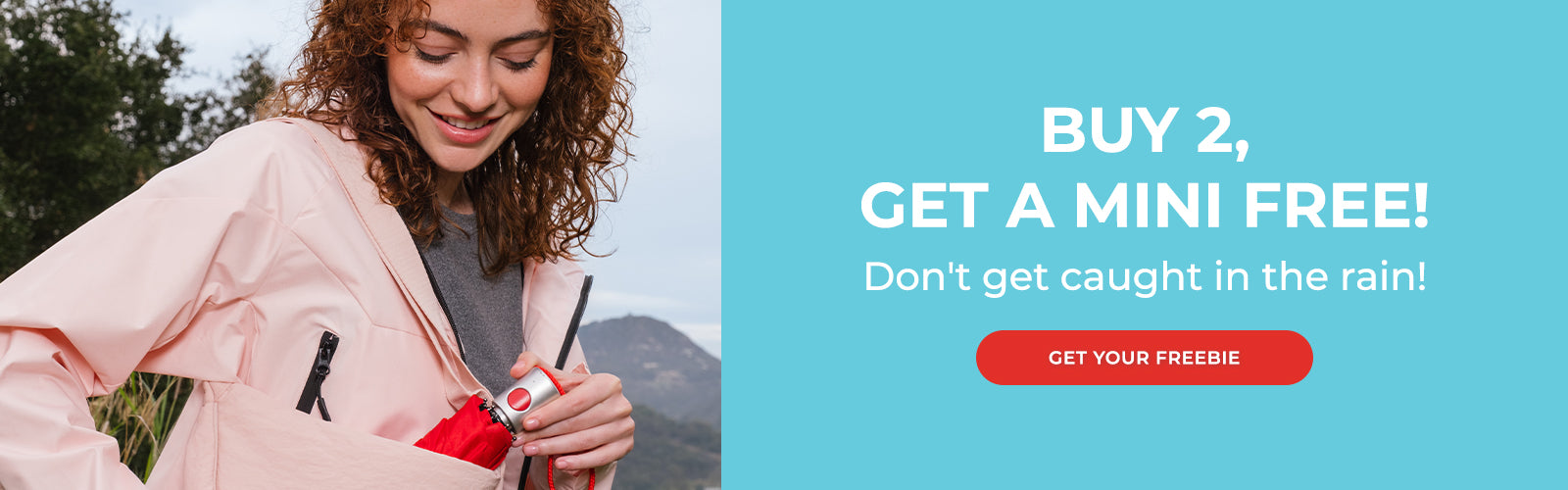 Promotional banner featuring a woman outdoors wearing a light pink waterproof jacket, holding a red umbrella, with text on the right reading 'BUY 2, GET A MINI FREE!' and a blue background.
