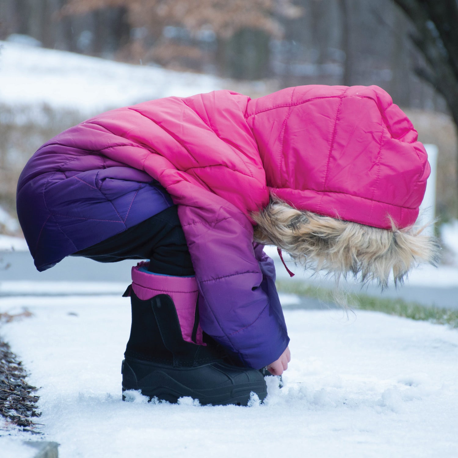Child model out in the snow wearing the Norah Winter boots