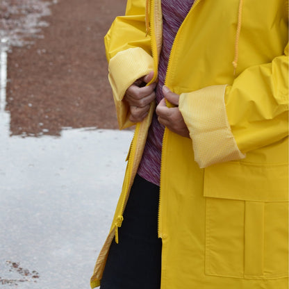 Woman wearing Lined Rain Slicker in yellow outside in rain