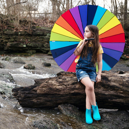 Girl sitting with Rainbow Stick Umbrella open